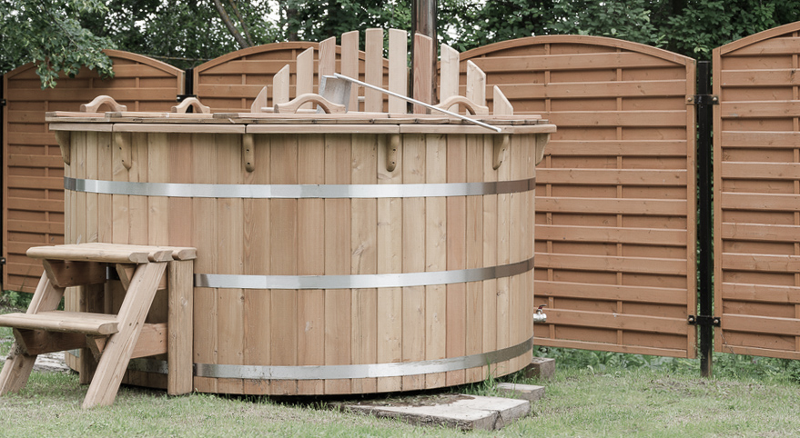wooden hot tub in backyard ready for a removal